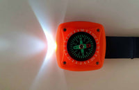 Orange square compass keychain with lit torch beam