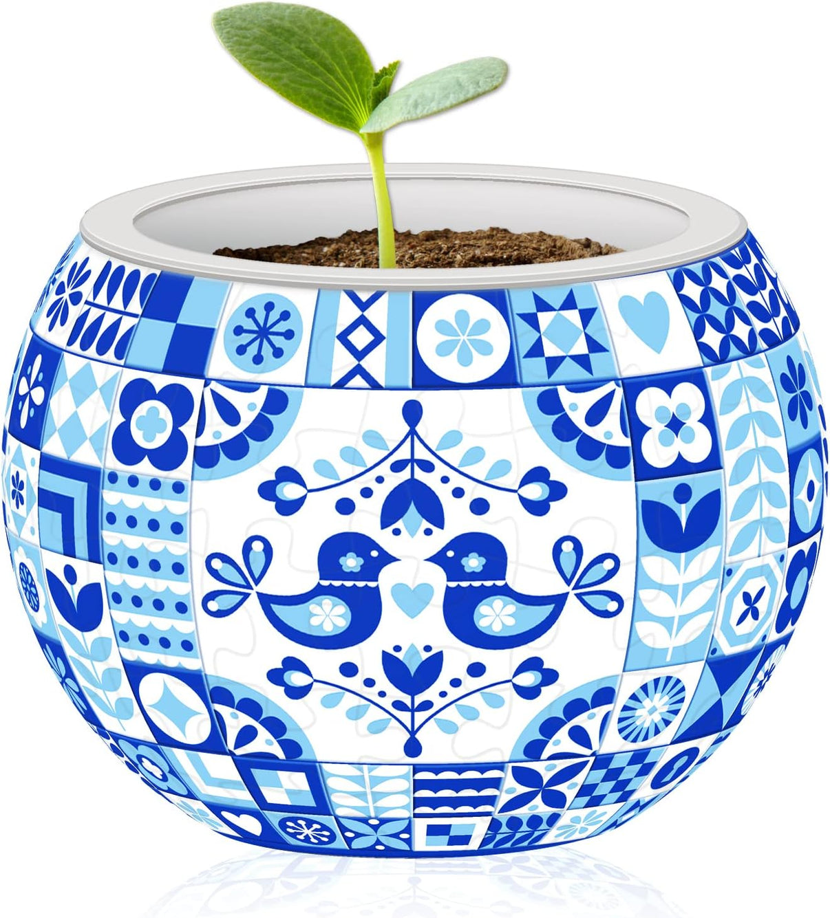 Blue-and-white patterned flowerpot with small green sprout in soil