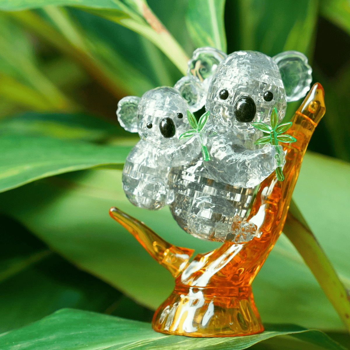 Crystal koala puzzle figurine of two koalas with amber-toned base