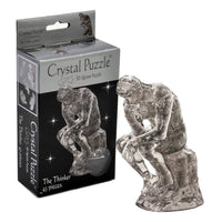 Crystal puzzle figure shaped like a thinker, clear gray translucent 3D design