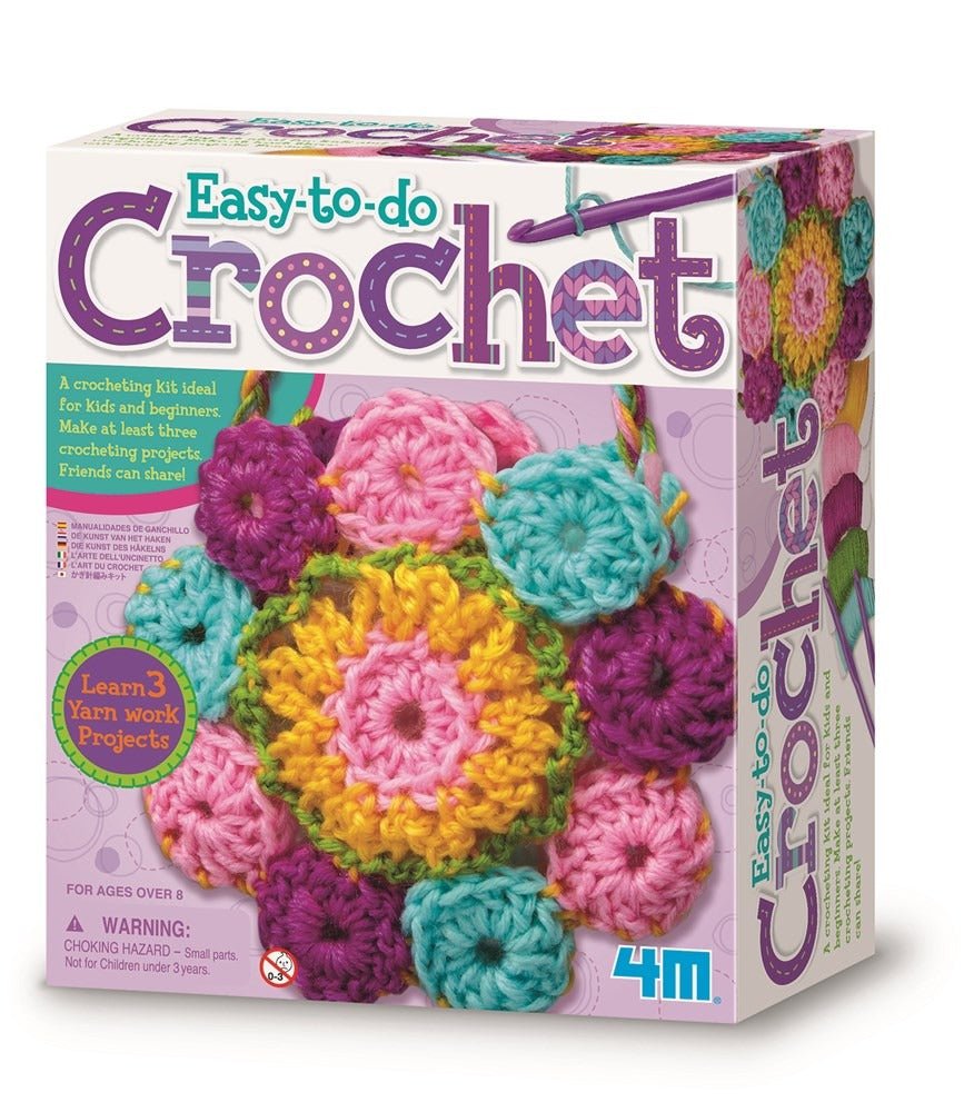 Crochet art kit box with colorful yarn balls and crocheted flower pieces