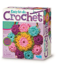 Crochet art kit box with colorful yarn balls and crocheted flower pieces