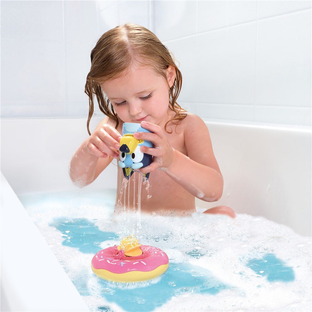 Bath splash float toy with character dispenser and blue/pink float ring