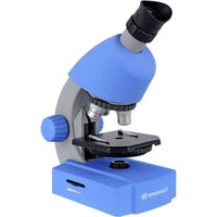 Blue educational compound microscope with black eyepiece and stage