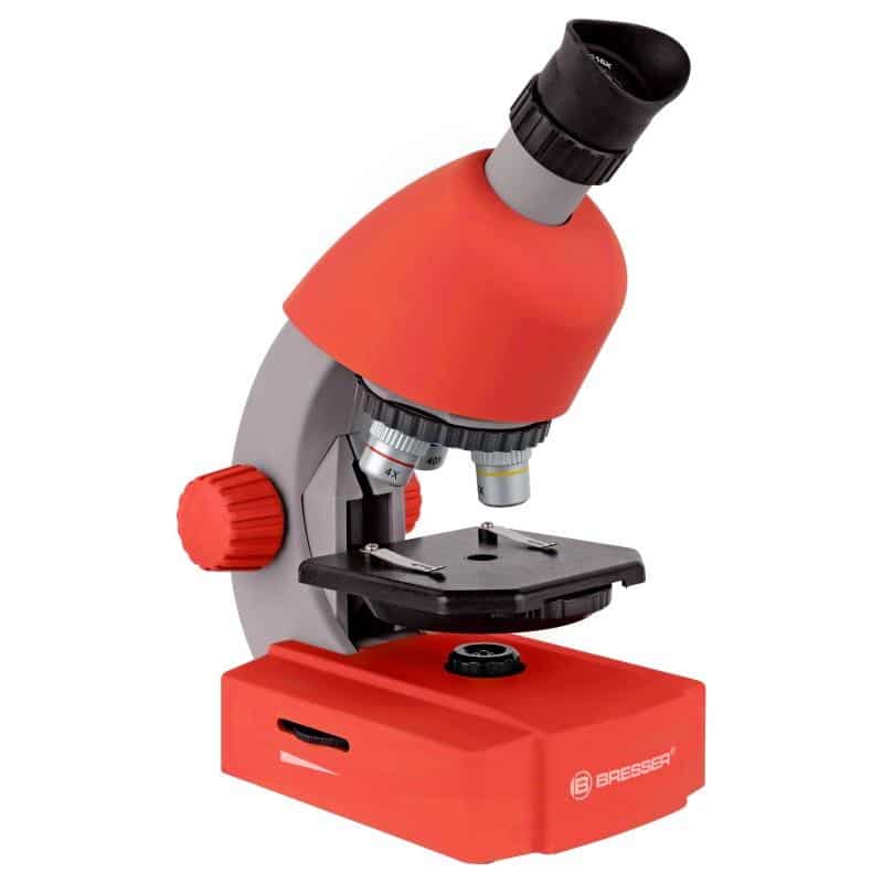 Red child microscope with black eyepiece, stage, and focus knobs