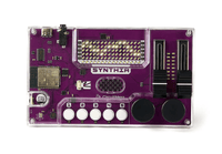 Purple SYNTHIA DIY synth kit in clear case, white buttons, two large knobs, sliders