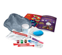Volcano science kit components with volcano mold, cups, tools, and colored powders