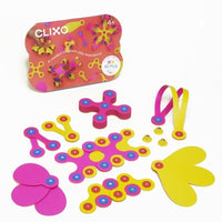 Pink and yellow magnetic building set pieces in a rectangular pack