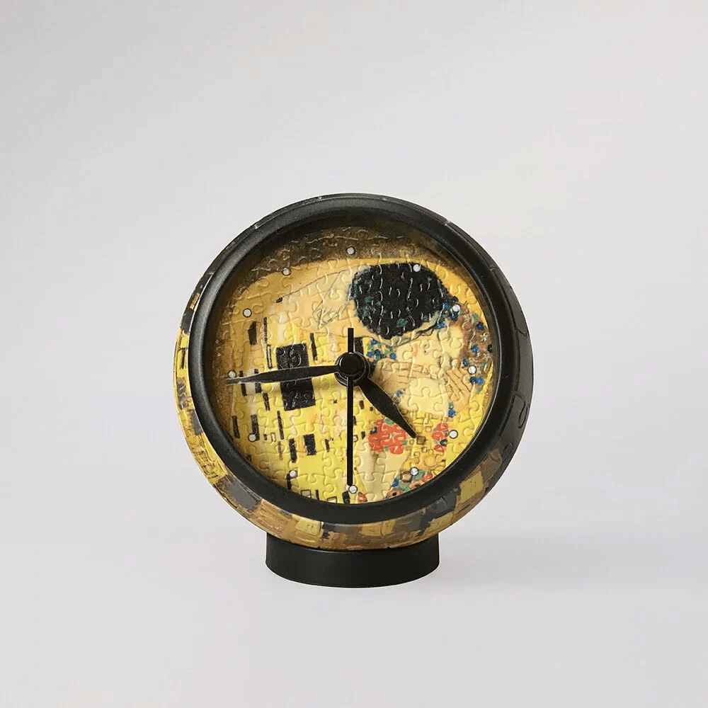 Round mantel clock with black outer ring and Klimt-style yellow art face.