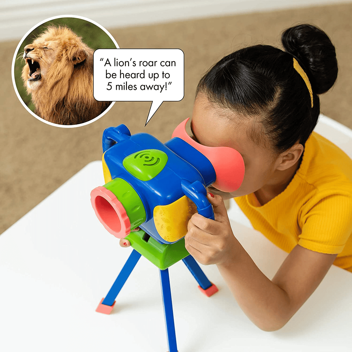Child using blue talking wildlife camera with green tripod legs