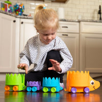 Hiding hedgehogs toy set with four colorful rolling hedgehog cars on a table