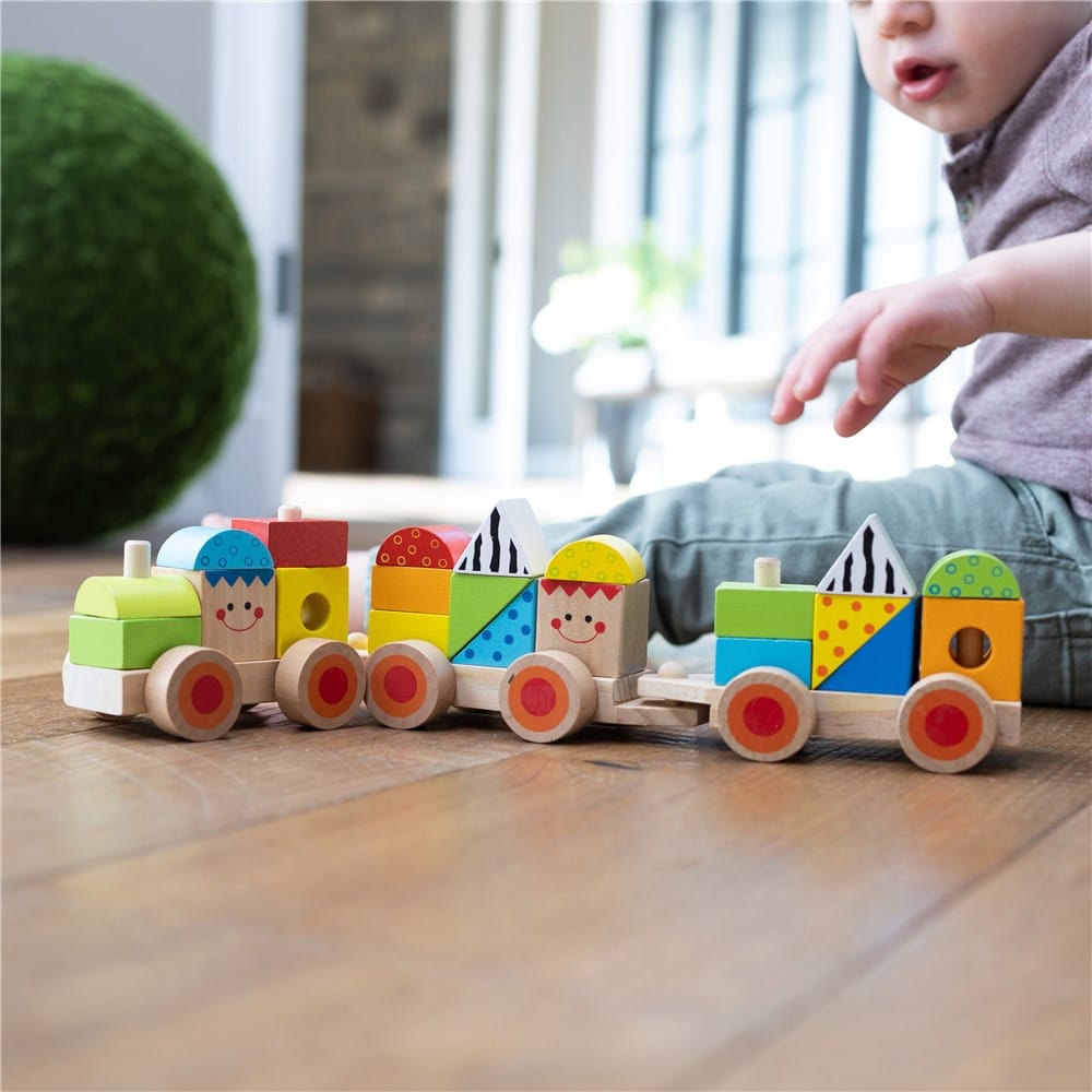 Colorful wooden locomotive train with block faces and red wheels