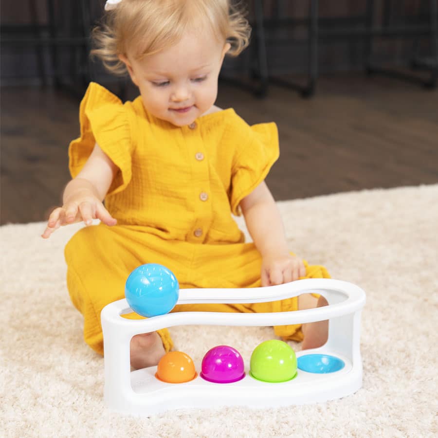 Roll again sorter toy with white frame and colorful dome pieces