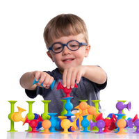 Colorful Squigz suction-cup connectors spread on a tabletop