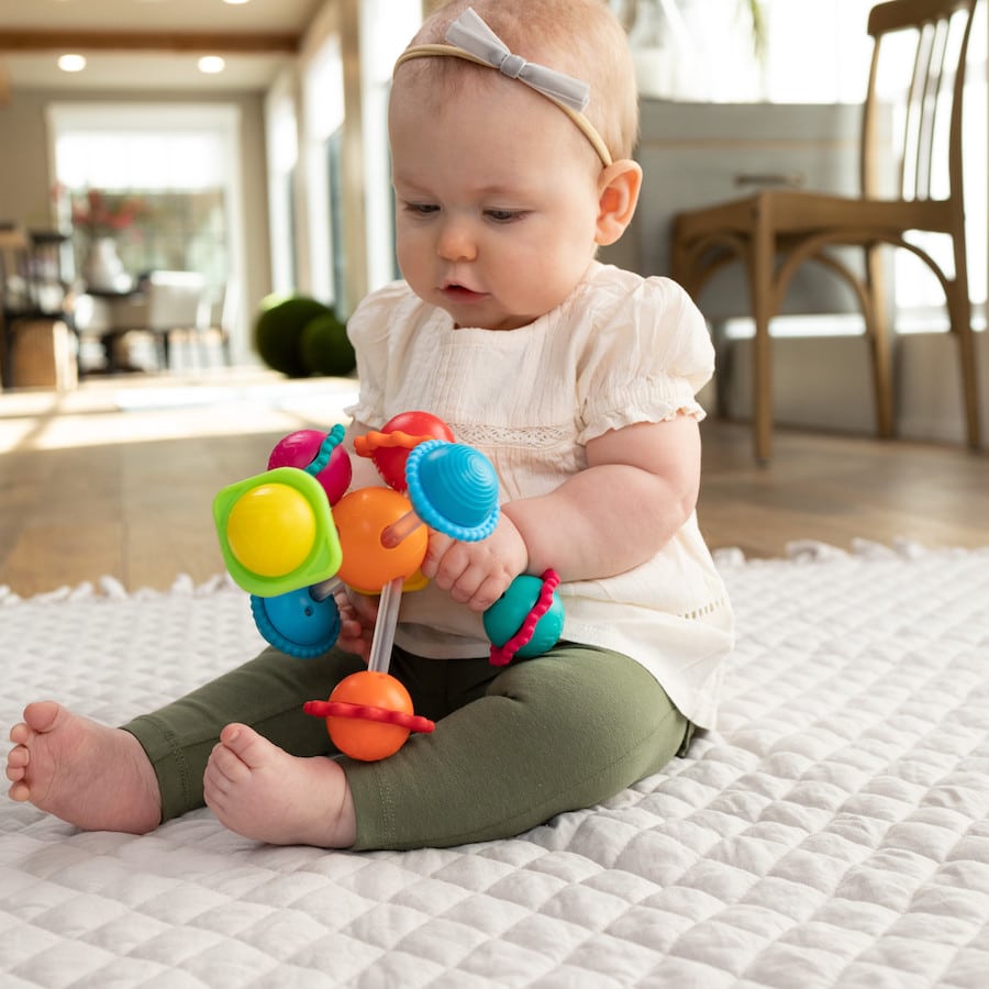 Wimzle sensory rattle toy with colorful gear-like beads and ring handles
