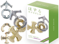 Hanayama Huzzle L3 Dolce cast puzzle pieces with gold and silver rings