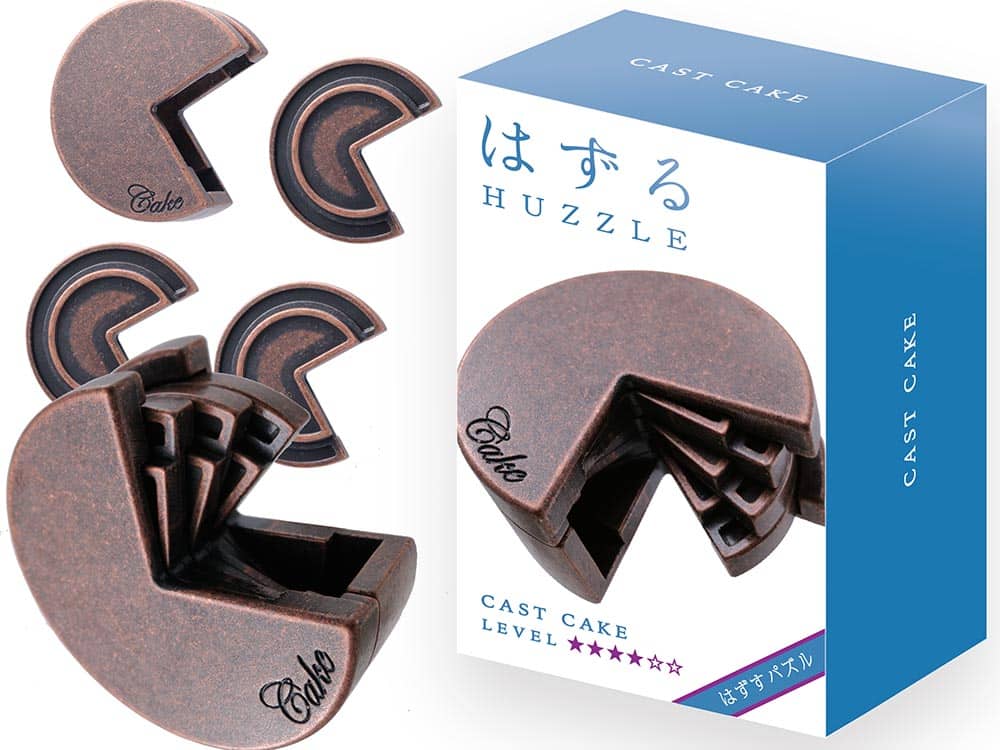 Dark brown cast metal cake puzzle pieces, curved interlocking shapes