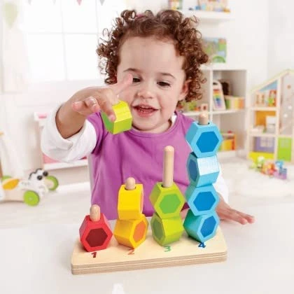 Multicolor counting stacker toy with wooden base and linked block stacks on pegs