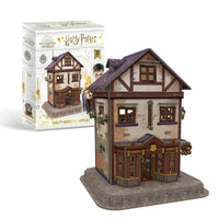 3D house puzzle with box, two-story facade, brown doors, purple roof, and windows
