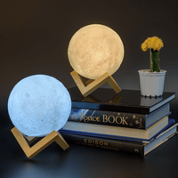 Moon LED night light set: blue and beige glowing discs on gold geometric stands