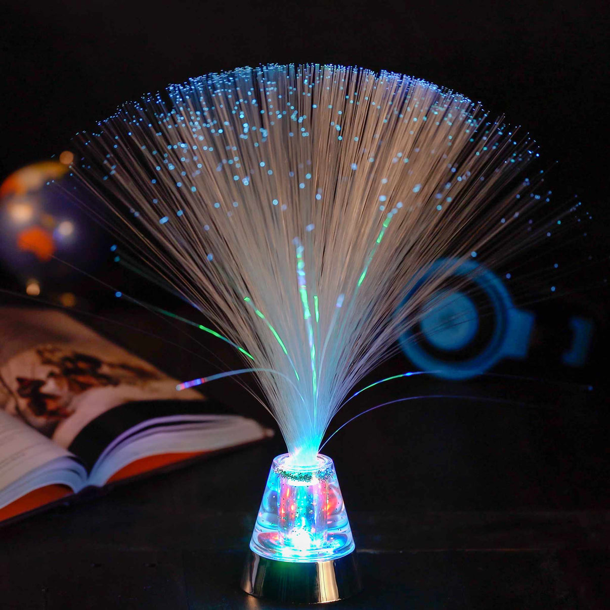 Optic fibre lamp with crystal base and multicolor light strands fanning upward