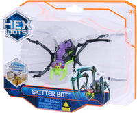 Skitter Bot toy in clear blister pack, black legs with purple body and green head