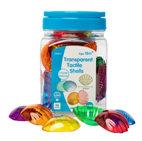 Transparent tactile shells in clear jar with blue lid and multicolor textured domes