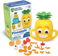 Yellow pineapple activity toy with green top, smiling face, and interchangeable orange pieces