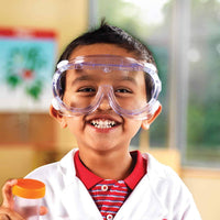 Child wearing clear safety goggles with transparent frame and head strap