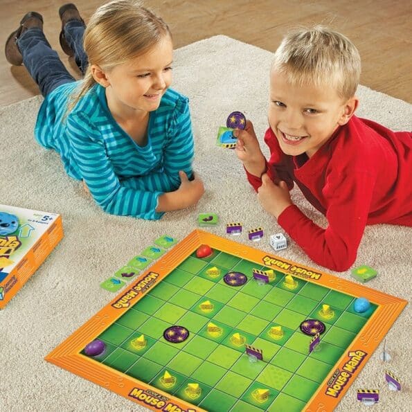 Kids playing a green and orange board game with purple mouse tokens
