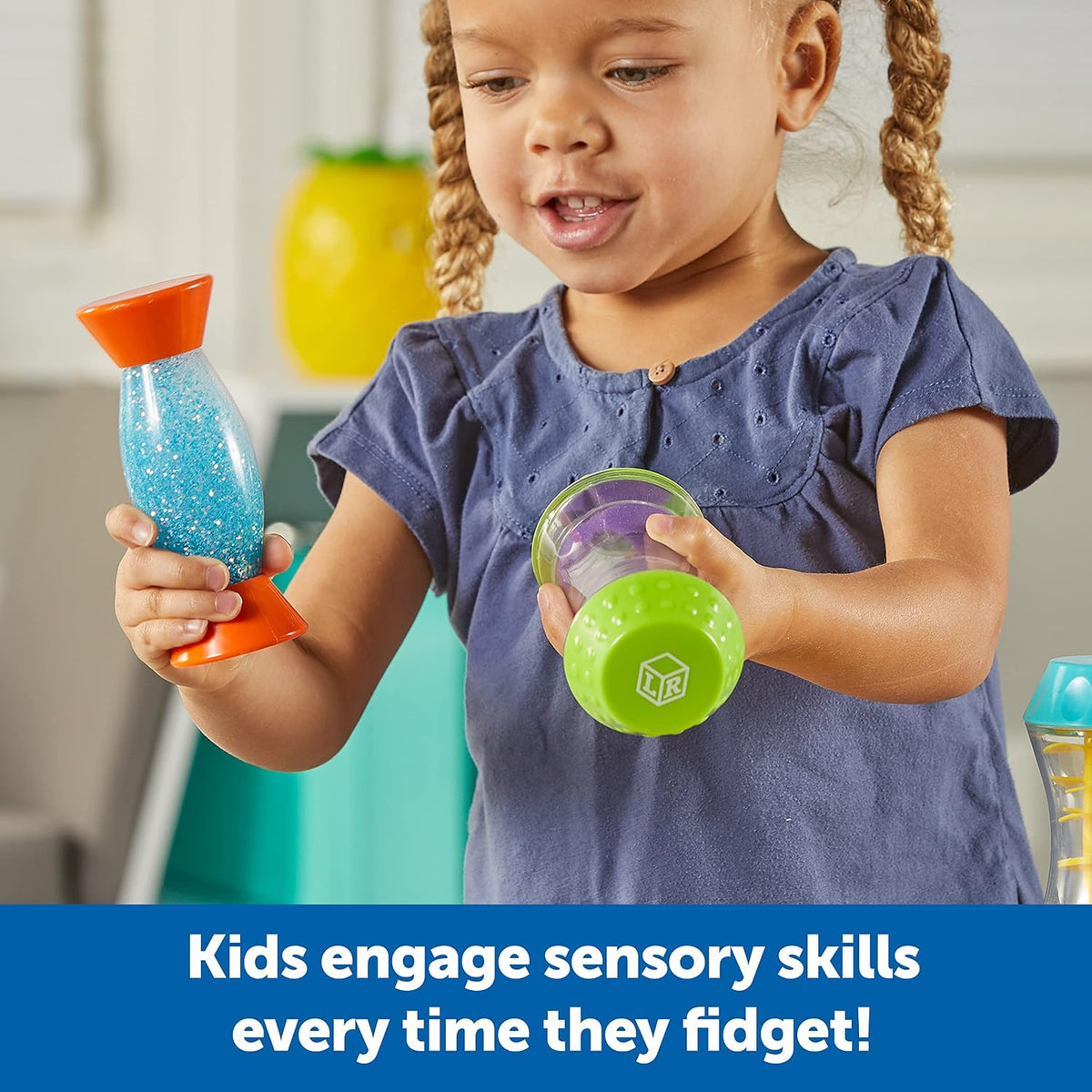 Child holding three colorful fidget tubes with glitter, beads, and sand inside