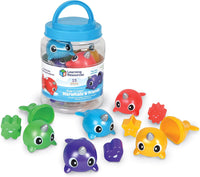 Assorted snap-together narwhal and sea-friend figures with blue-lidded storage jar
