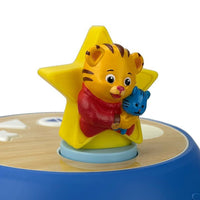 Tiger figurine with red scarf and blue animal on yellow star on light blue circular base
