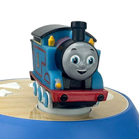 Blue toy train engine with smiling face, red base, on a circular track.