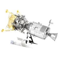 Metal model of Apollo spacecraft on stand with gray body, black panels, and yellow framework