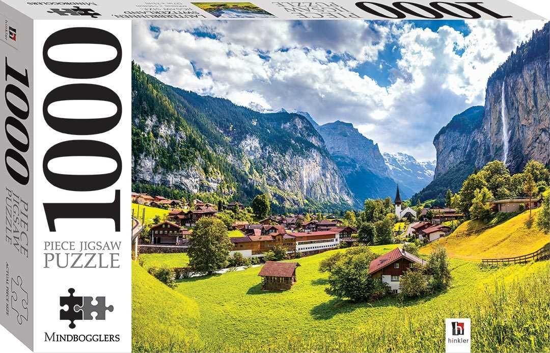 Jigsaw puzzle box showing Swiss alpine valley with village houses, green meadows, and mountains