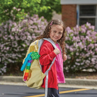 Colorful number-block bubble popper clipped to a backpack, green and blue pieces