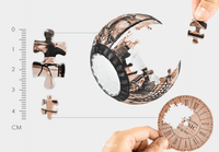 Puzzle clock assembly with jigsaw pieces and a hand holding the clock ring bezel