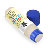 Puzzle glue tube with blue screw cap and nozzle end