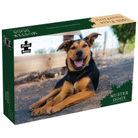 Jigsaw puzzle box with a smiling dog lying on a forest path, green branding