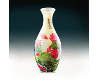 Lotus puzzle vase with slim white neck, red pink flowers and green landscape pattern