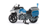 Blue and white police motorcycle toy with blue POLIZEI side panel and front lights