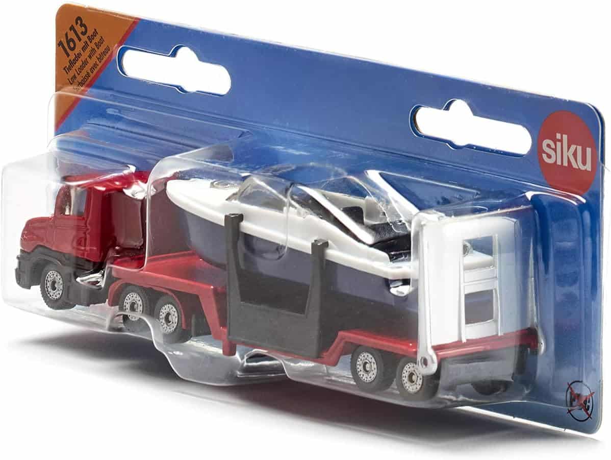 Siku toy low loader truck in red with blue trailer carrying a boat, in retail blister