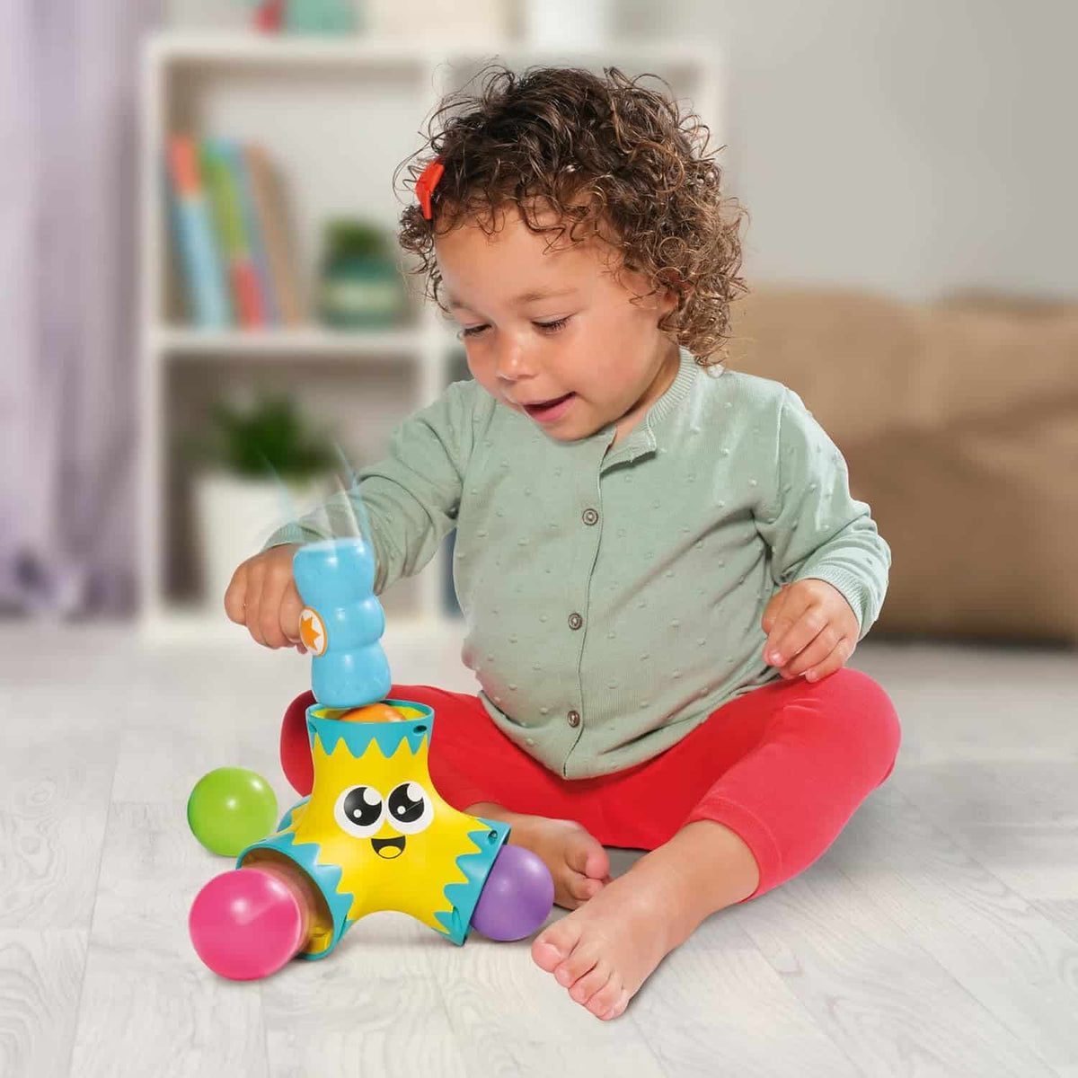 Tomy Toomies Bash & Pop star popper toy with colorful balls, shown in use