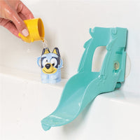 Teal waterslide bath toy with yellow water funnel and Bluey-style character