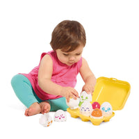Squeaky egg toy set with yellow tray and cute character face eggs