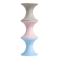 Moluk Tulu stacking toy set, three pastel hourglass pieces in gray, pink, blue