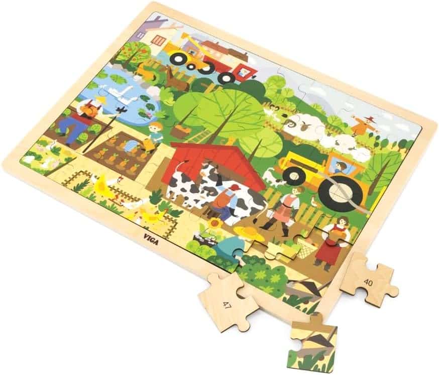 Farm wooden jigsaw puzzle board with loose pieces and partial scene