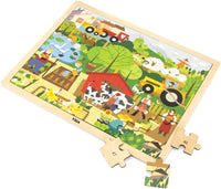 Farm wooden jigsaw puzzle board with loose pieces and partial scene