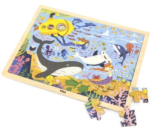 Sea life jigsaw puzzle board with scattered pieces, featuring whales, dolphins, and fish